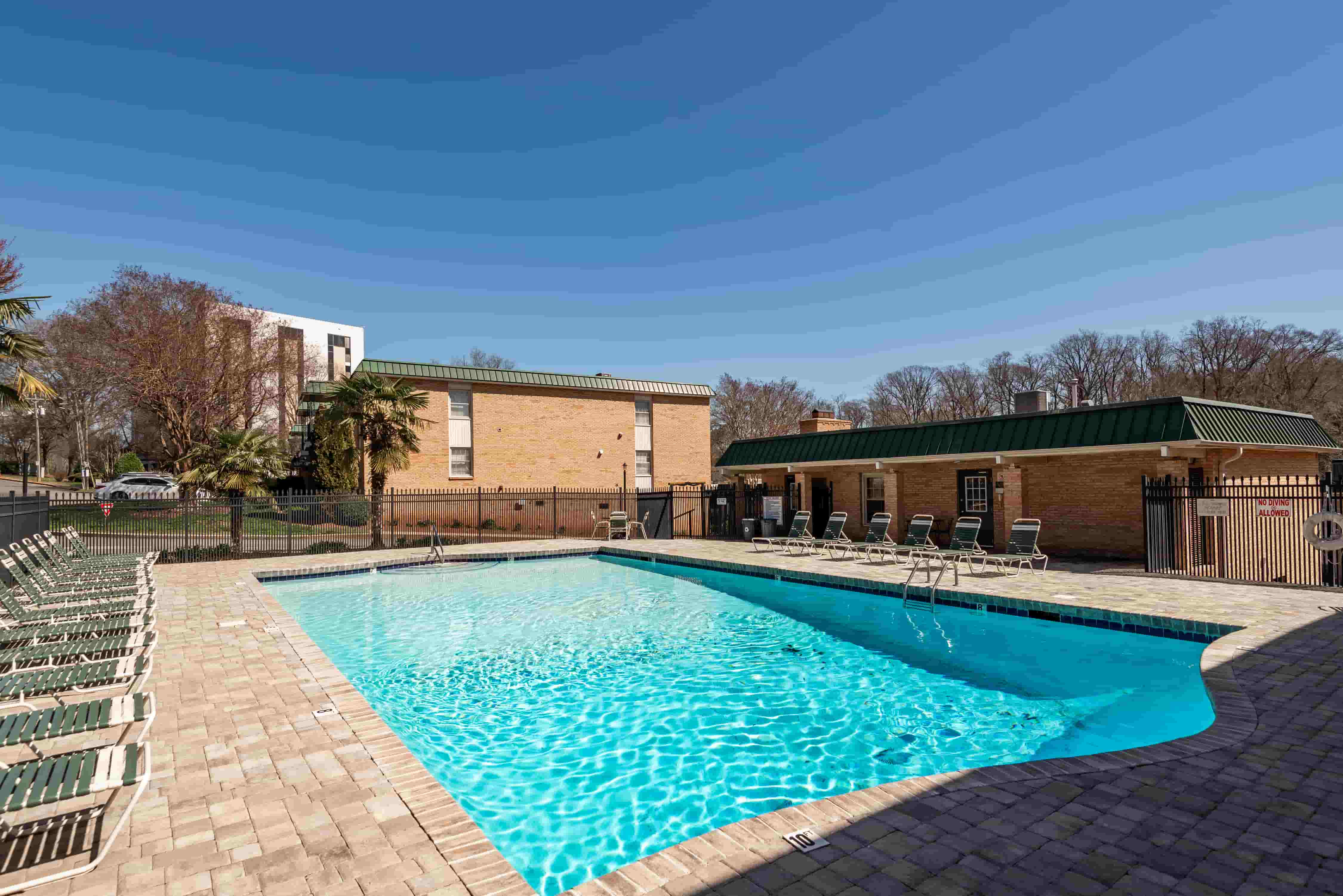 Franciscan Terrace pool facing the clubhouse — paver deck and seating